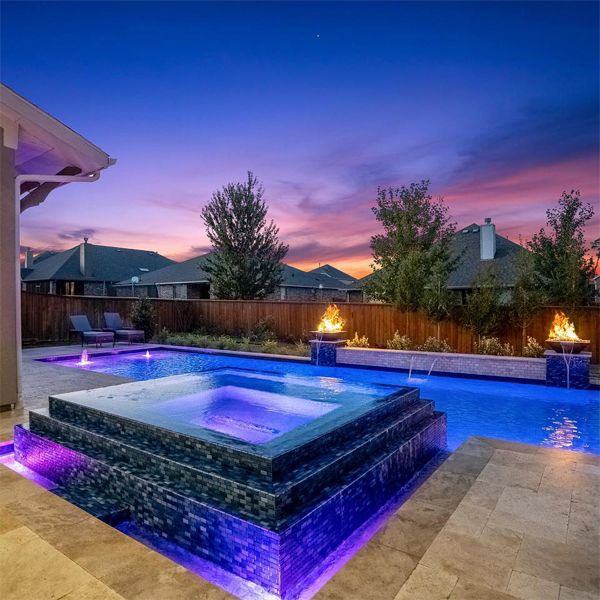 private pool and hot tub lighted at night, by Backyard Oasis