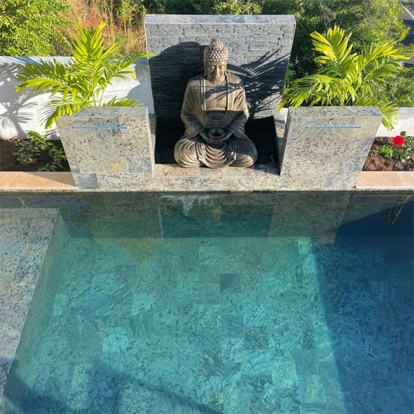 Private small swimming pool with a Zen design and natural stone coating, by Sarana Pools, decorated with waterfalls and a figure of Buddha