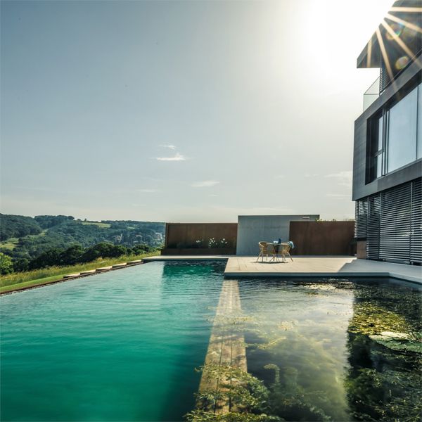 natural infinity pool, by Biotop, in a house with a modern and minimalist design