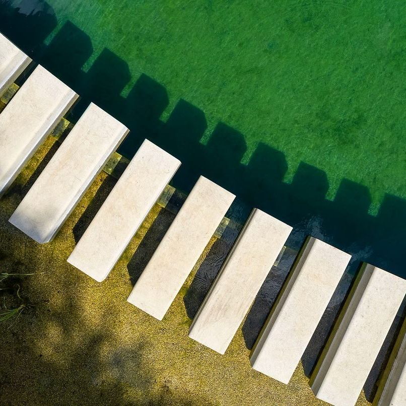 Aerial view of the floating steps in a natural pool by Gartenart