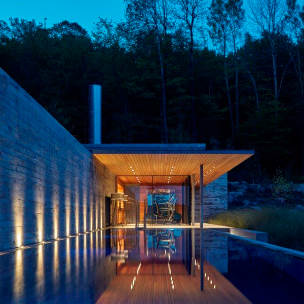 overflow pool and spa at night by MacKay-Lyons Sweetapple Architects