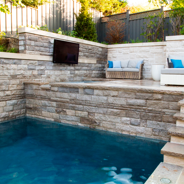 pool with a waterfall and spa by Todd Pools