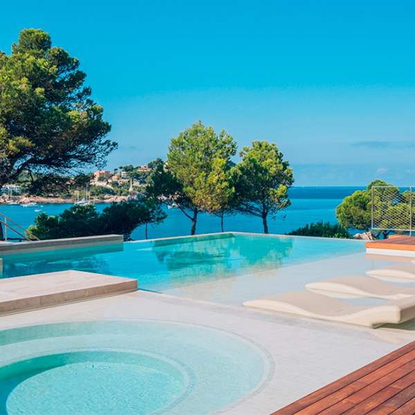 vista del horizonte desde la zona spa de una piscina desbordante con zona relax