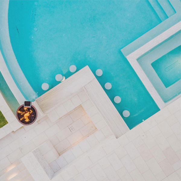 drone view of a custom infinity pool with spa by GW Oliver