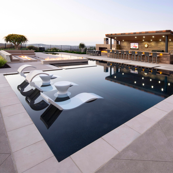 relax area in a black pool by Mission Pools