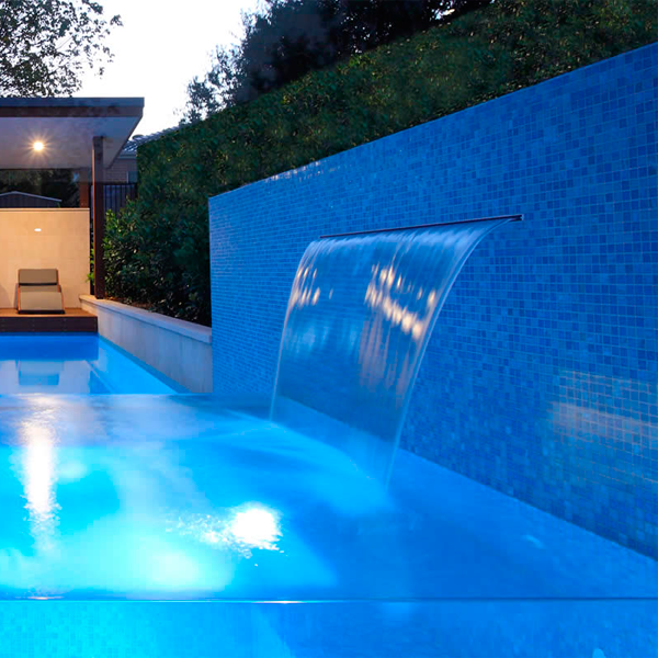 transparent spa overflowing a swimming pool