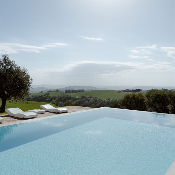 Infinity pool in a rustic space, in the middle of the countryside, from a project by Wespi de Meuron Romeo Architetti