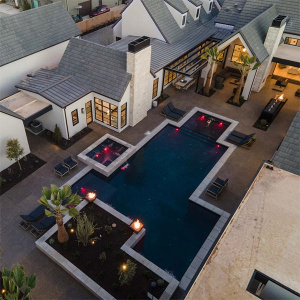 drone view of a private pool in a geometric design with built-in spa, by Palmer Pools, built in the garden of a single-family house