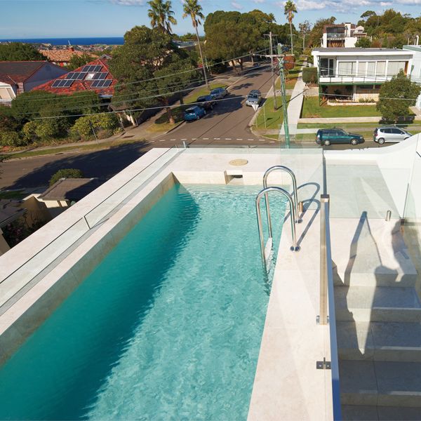 Elegant pool on the rooftop of a private house, by Artesian Pools, with external stairs to the access area