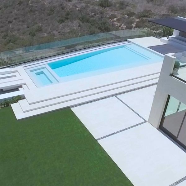 white infinity pool with built-in spa, by Monaco Luxury Pools