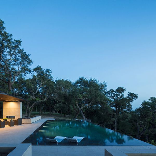 minimalist infinity pool at night, in a project by Murray Legge Architecture