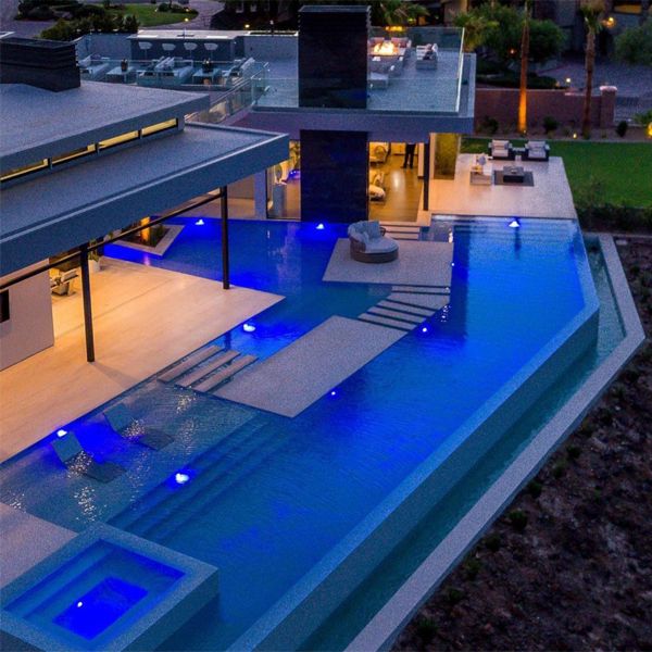 luxury infinity pool with spa at night, by California Pools