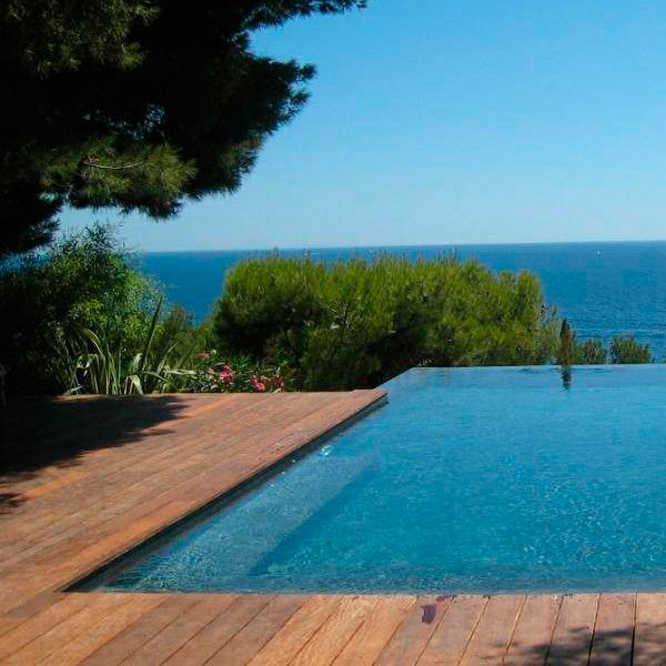 sea view from a custom infinity pool by Jacques Hugony, surrounded by wooden deck