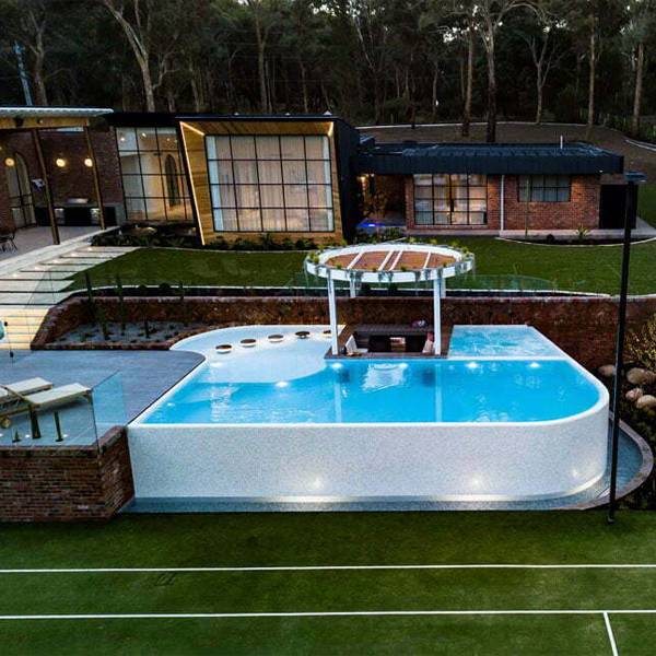 different overflow pool with spa drone view by Striking Pools