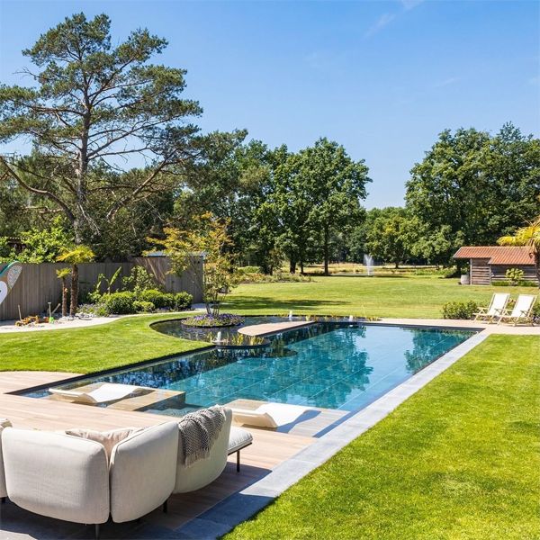 Modern natural pool design in a large garden, by Cockheyt Biopools