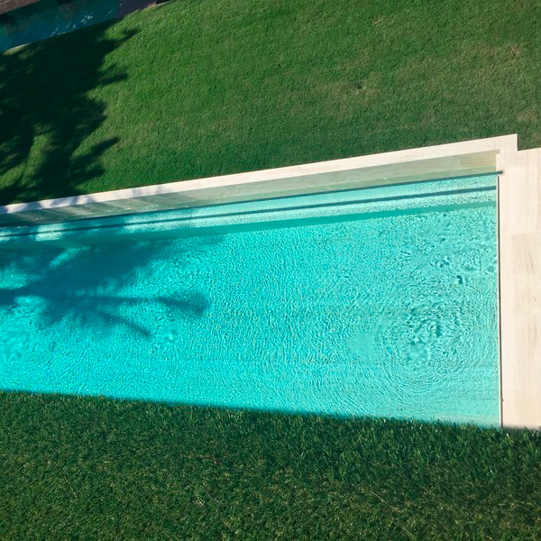 transparent infinity lap pool by Regency Pool and Spa