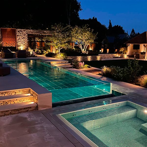transparent infinity pool and spa at night, by Guncast