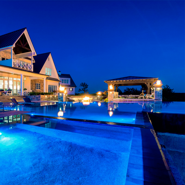 mirror pool and spa at night by J. Brownlee Design