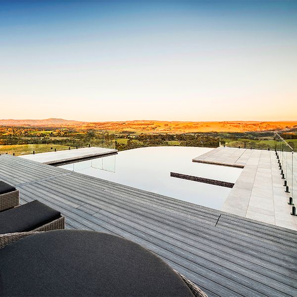 Custom infinity pool, mirror effect, with built-in spa, by Esjay Landscapes