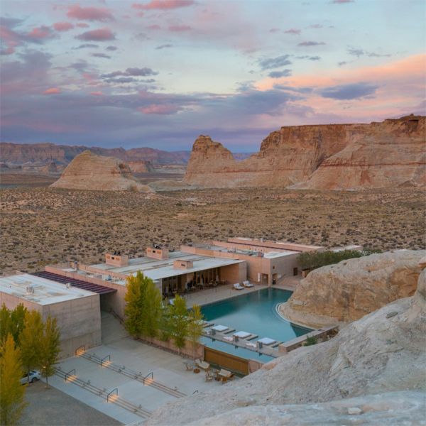 drone view of an impressive infinity pool surrounded by rocks in the middle of the desert, in a project by Wendell Burnette Architects