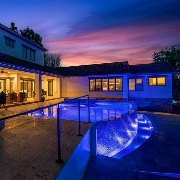 Custom infinity `pool by All Custom Pools, lighted at night
