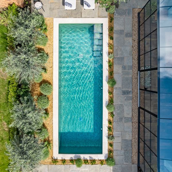drone view of a bright tile private pool by Aquaria Pools
