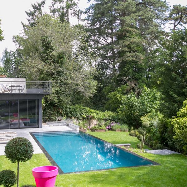 minimalist infinity pool in a garden of a project by Peguet Paysages