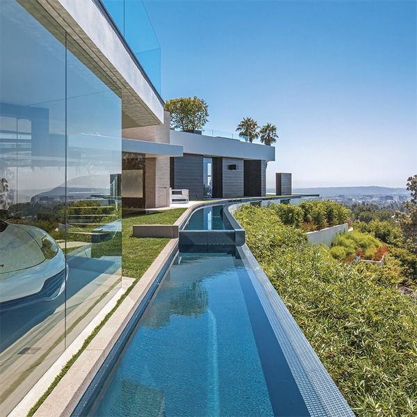 custom swim lane around a modern house, in a project by Whipple Russell Architects