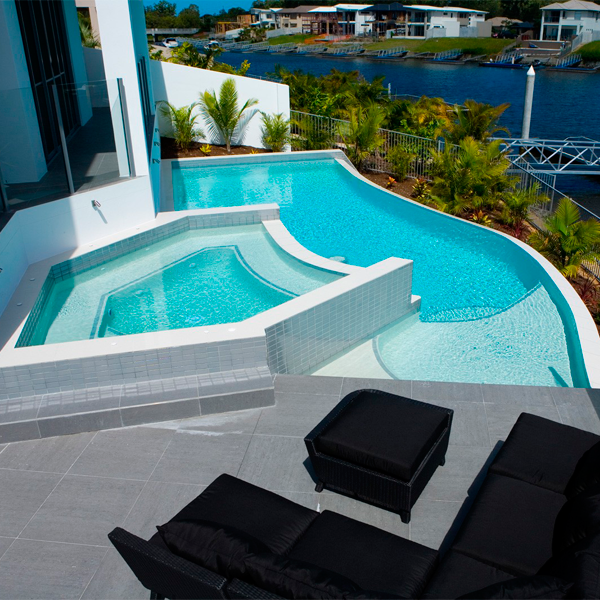 custom infinity pool with raised spa by Brisbane Pools and Landscapes