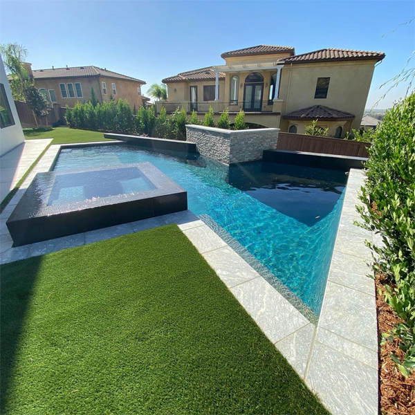 private geometric pool with raised spa by Progressive Landscapes