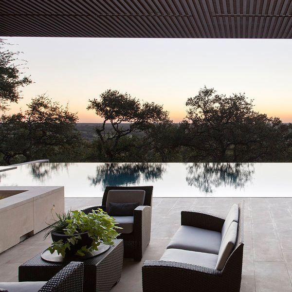 mirror pool view from the exterior living room, at sunset, in a project by Murray Legge Architecture