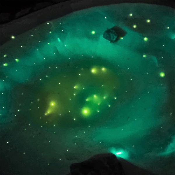 a starry sky at the bottom of a mini sand pool, by Beach pool, using fiber optic lighting