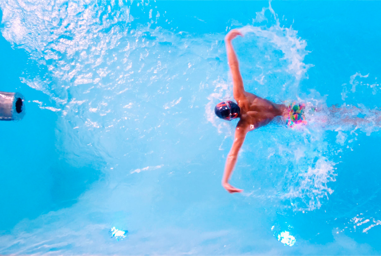 Woman swimming in mini pool with counter current swimming equipment
