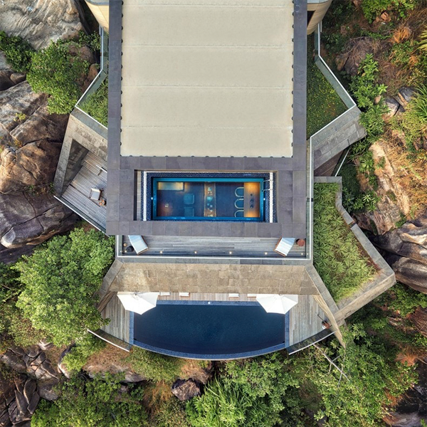 drone view of two pools: an infinity pool and a transparent pool in a great project by Studio RHE