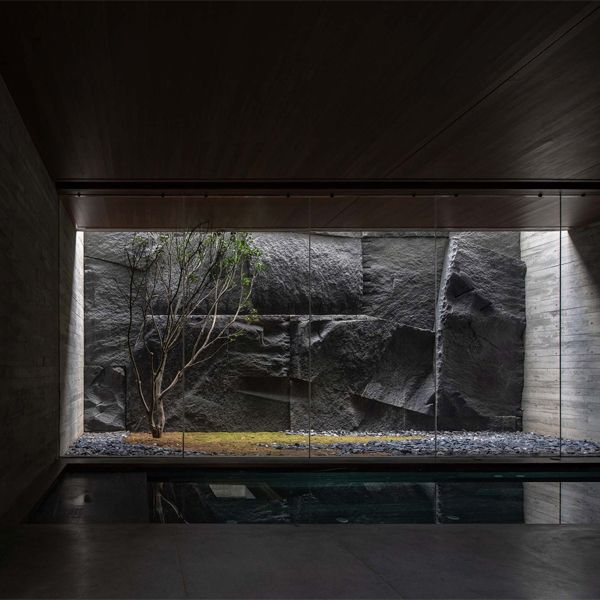 minimalist indoor pool with a large window to an interior zen garden, in a project by More Than Arch Studio