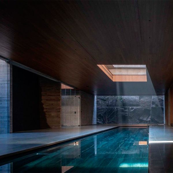 minimalist indoor lap pool with a large window in the ceiling, in a luxury project by More Than Arch Studio