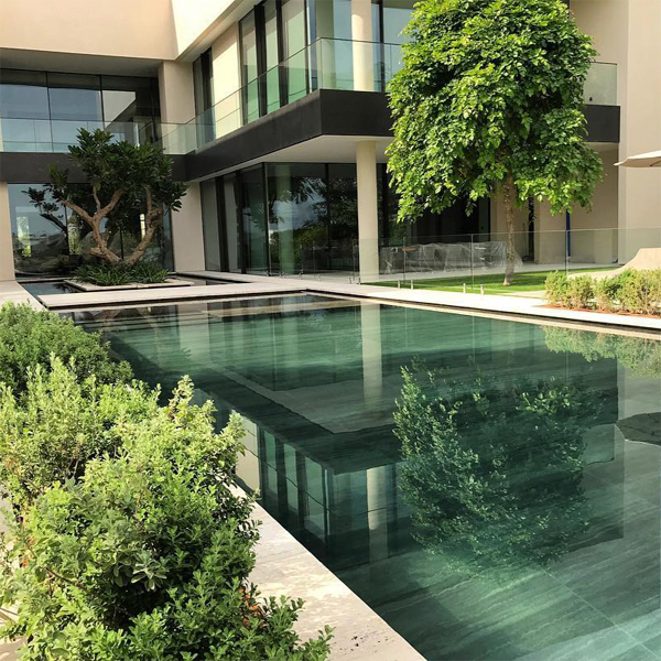 Moderna piscina infinita y jardín, por Satma International