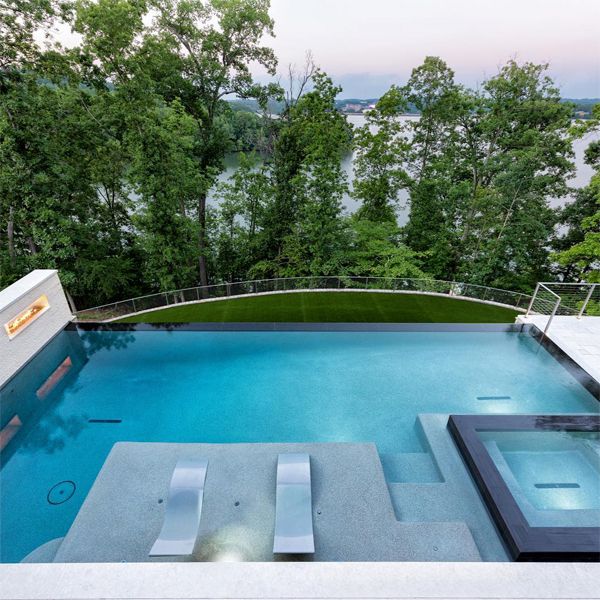 Piscine à débordement par Signature Luxury Pools, avec spa intégré et vue magnifique sur le lac